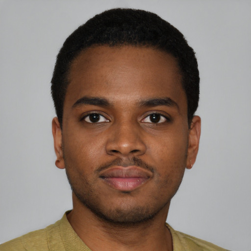 Joyful black young-adult male with short  brown hair and brown eyes