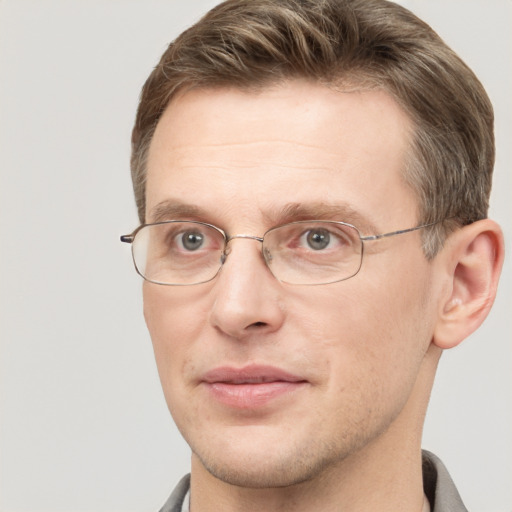 Joyful white adult male with short  brown hair and grey eyes