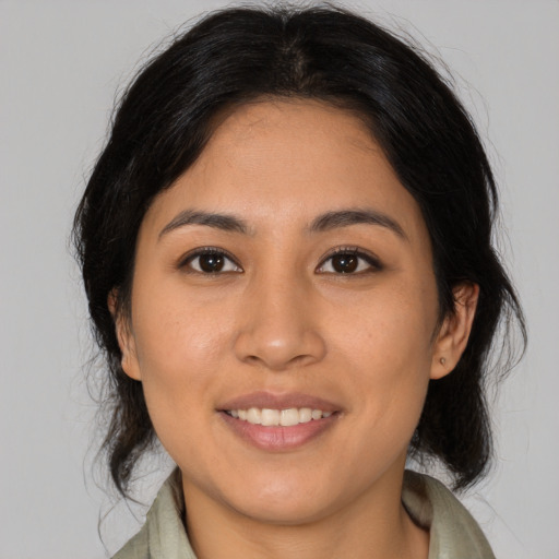 Joyful latino young-adult female with medium  brown hair and brown eyes