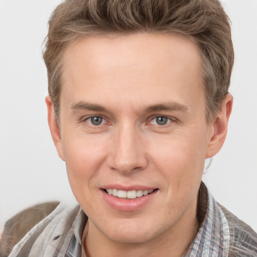 Joyful white adult male with short  brown hair and grey eyes