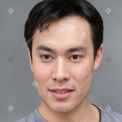 Joyful asian young-adult male with short  brown hair and brown eyes