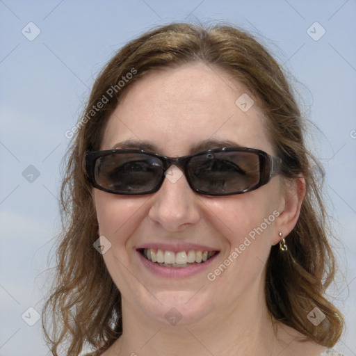 Joyful white adult female with medium  brown hair and blue eyes