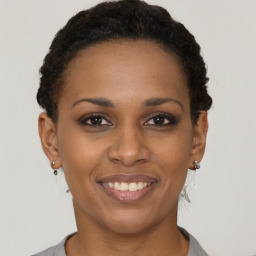 Joyful black young-adult female with short  brown hair and brown eyes