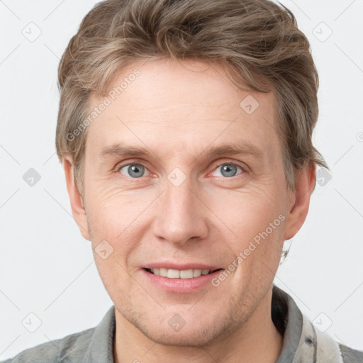 Joyful white adult male with short  brown hair and grey eyes