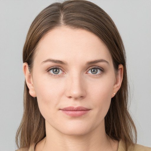 Joyful white young-adult female with medium  brown hair and grey eyes