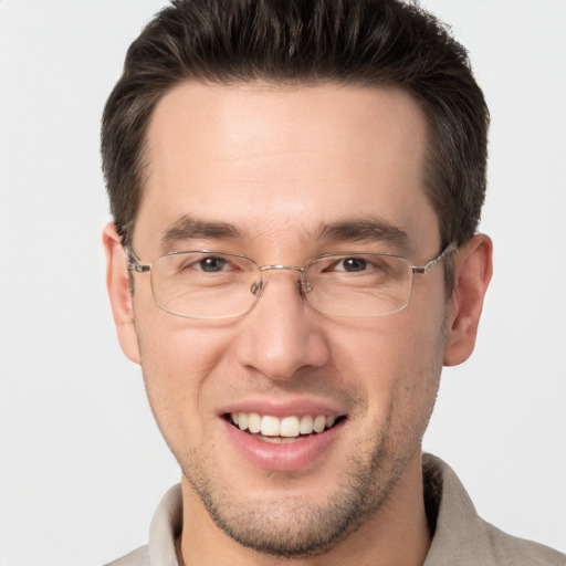 Joyful white adult male with short  brown hair and brown eyes