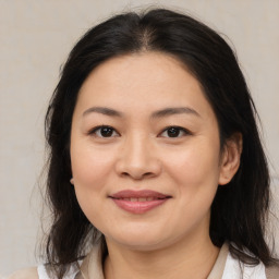 Joyful asian young-adult female with medium  brown hair and brown eyes