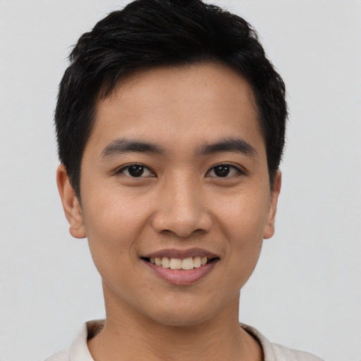Joyful asian young-adult male with short  black hair and brown eyes