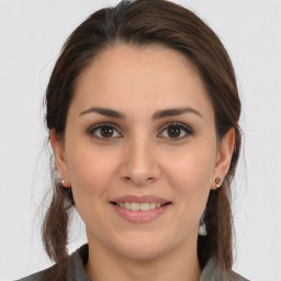 Joyful white young-adult female with medium  brown hair and brown eyes