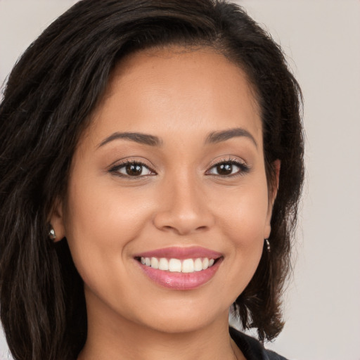 Joyful white young-adult female with long  brown hair and brown eyes