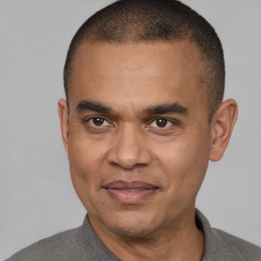 Joyful latino adult male with short  brown hair and brown eyes