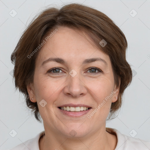 Joyful white adult female with medium  brown hair and grey eyes