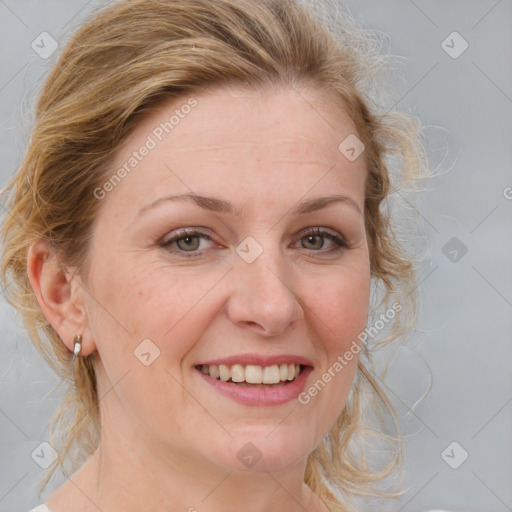 Joyful white adult female with medium  brown hair and blue eyes