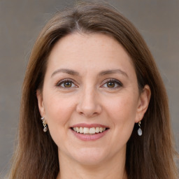 Joyful white adult female with long  brown hair and grey eyes