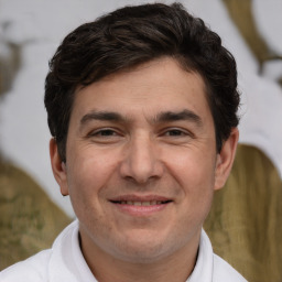 Joyful white adult male with short  brown hair and brown eyes