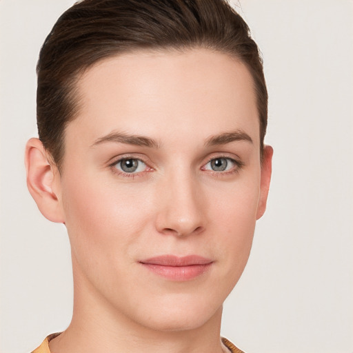 Joyful white young-adult female with short  brown hair and grey eyes