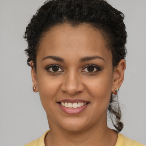 Joyful latino young-adult female with short  brown hair and brown eyes