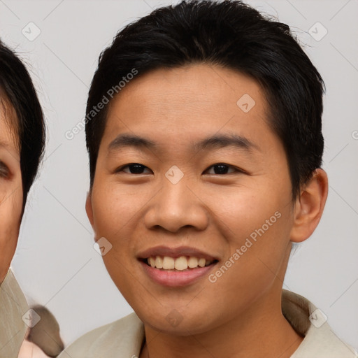 Joyful asian young-adult male with short  brown hair and brown eyes