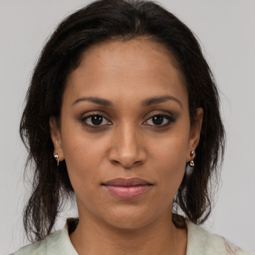Joyful black young-adult female with medium  brown hair and brown eyes