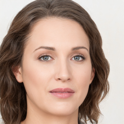 Joyful white young-adult female with medium  brown hair and green eyes