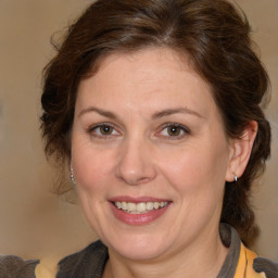 Joyful white adult female with medium  brown hair and brown eyes