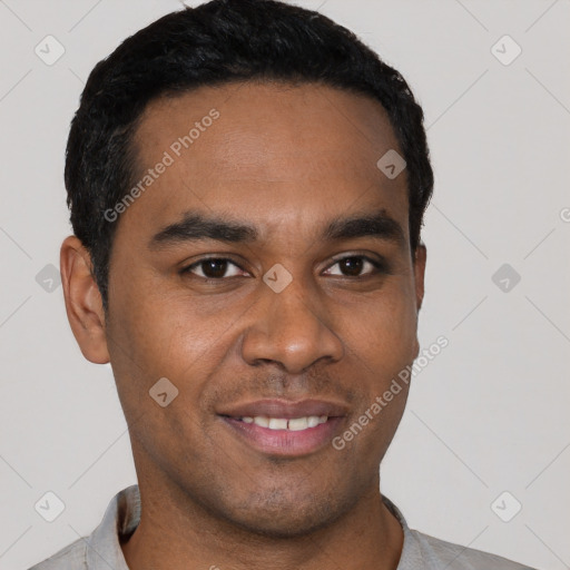 Joyful black young-adult male with short  black hair and brown eyes