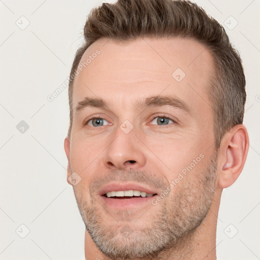 Joyful white adult male with short  brown hair and brown eyes