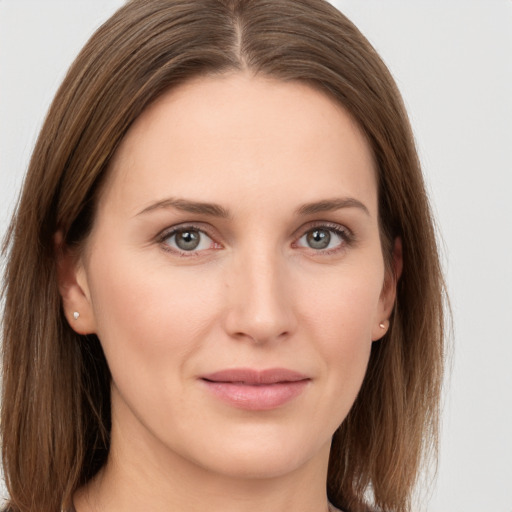 Joyful white young-adult female with long  brown hair and grey eyes