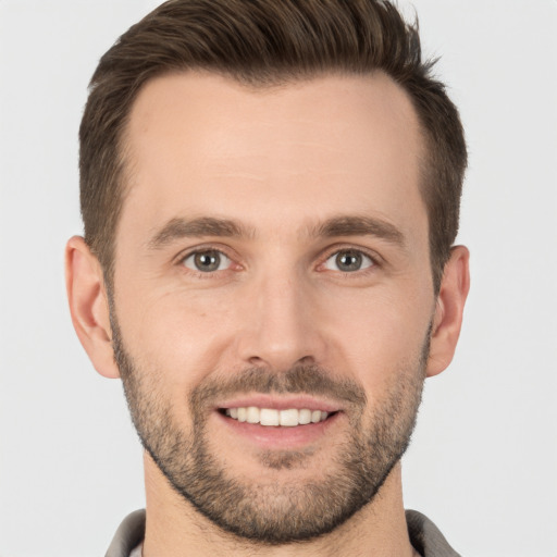 Joyful white young-adult male with short  brown hair and brown eyes