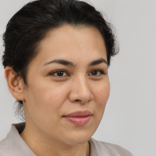 Joyful latino young-adult female with short  brown hair and brown eyes