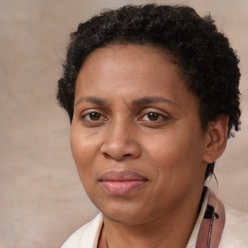 Joyful black adult female with short  brown hair and brown eyes