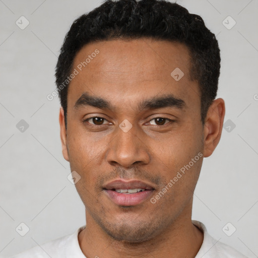 Joyful latino young-adult male with short  black hair and brown eyes