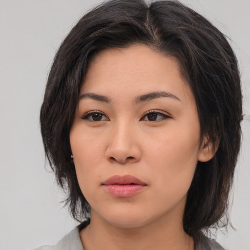 Neutral asian young-adult female with medium  brown hair and brown eyes