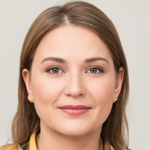 Joyful white young-adult female with medium  brown hair and grey eyes