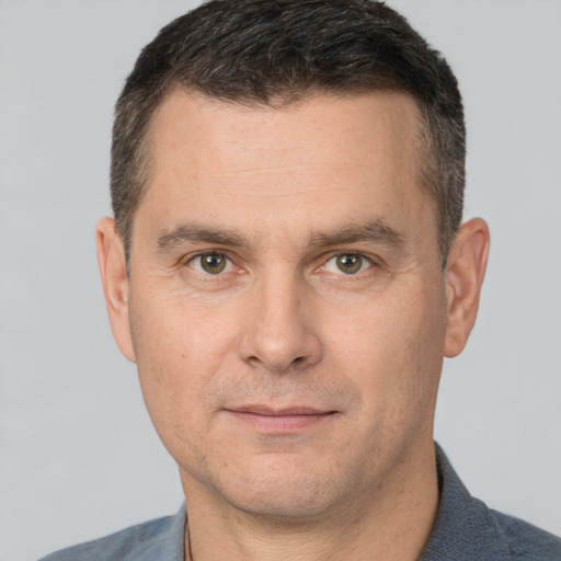 Joyful white adult male with short  brown hair and brown eyes