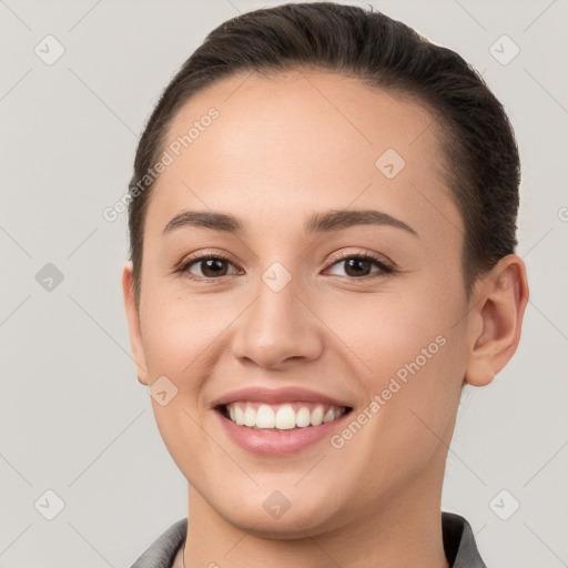 Joyful white young-adult female with short  brown hair and brown eyes