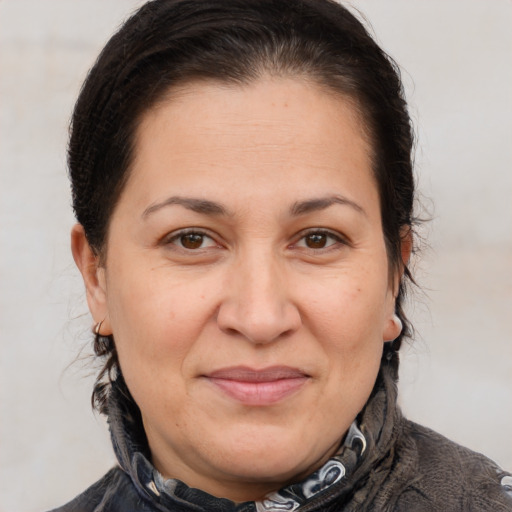 Joyful white adult female with medium  brown hair and brown eyes