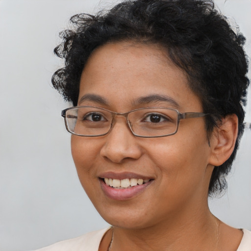 Joyful latino adult female with short  brown hair and brown eyes