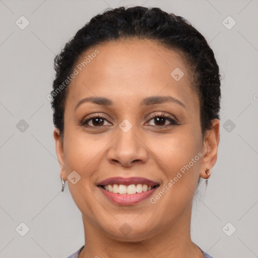 Joyful black young-adult female with short  brown hair and brown eyes