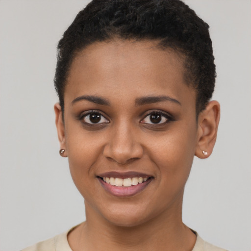 Joyful black young-adult female with short  brown hair and brown eyes