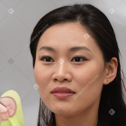 Joyful asian young-adult female with long  brown hair and brown eyes