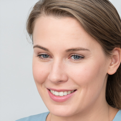 Joyful white young-adult female with medium  brown hair and blue eyes