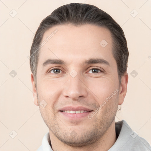 Joyful white young-adult male with short  brown hair and brown eyes