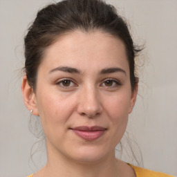 Joyful white young-adult female with medium  brown hair and brown eyes