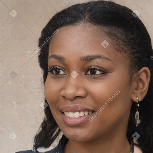 Joyful black young-adult female with long  brown hair and brown eyes