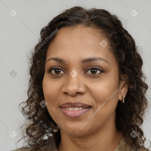 Joyful black young-adult female with long  brown hair and brown eyes