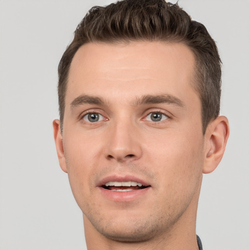 Joyful white young-adult male with short  brown hair and brown eyes