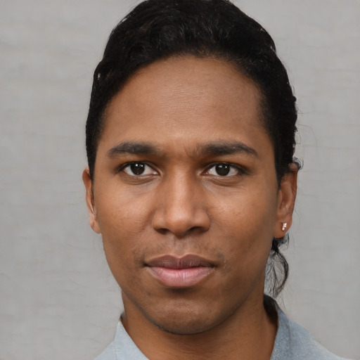 Joyful black young-adult male with short  black hair and brown eyes