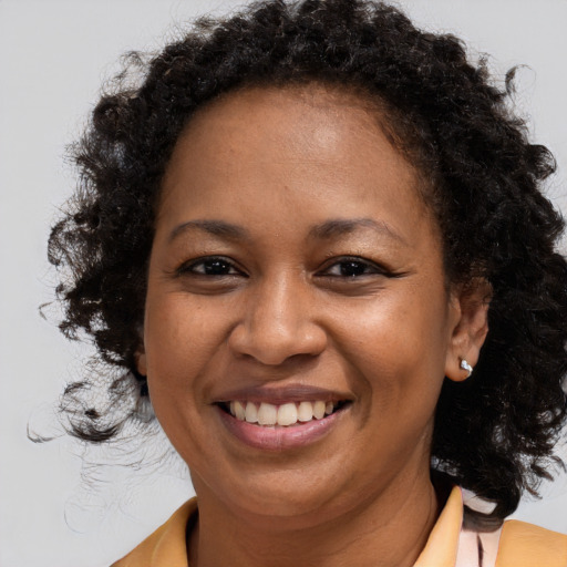 Joyful black young-adult female with medium  brown hair and brown eyes