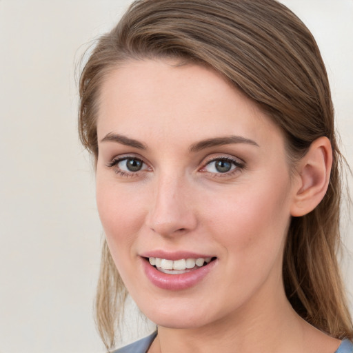 Joyful white young-adult female with medium  brown hair and blue eyes